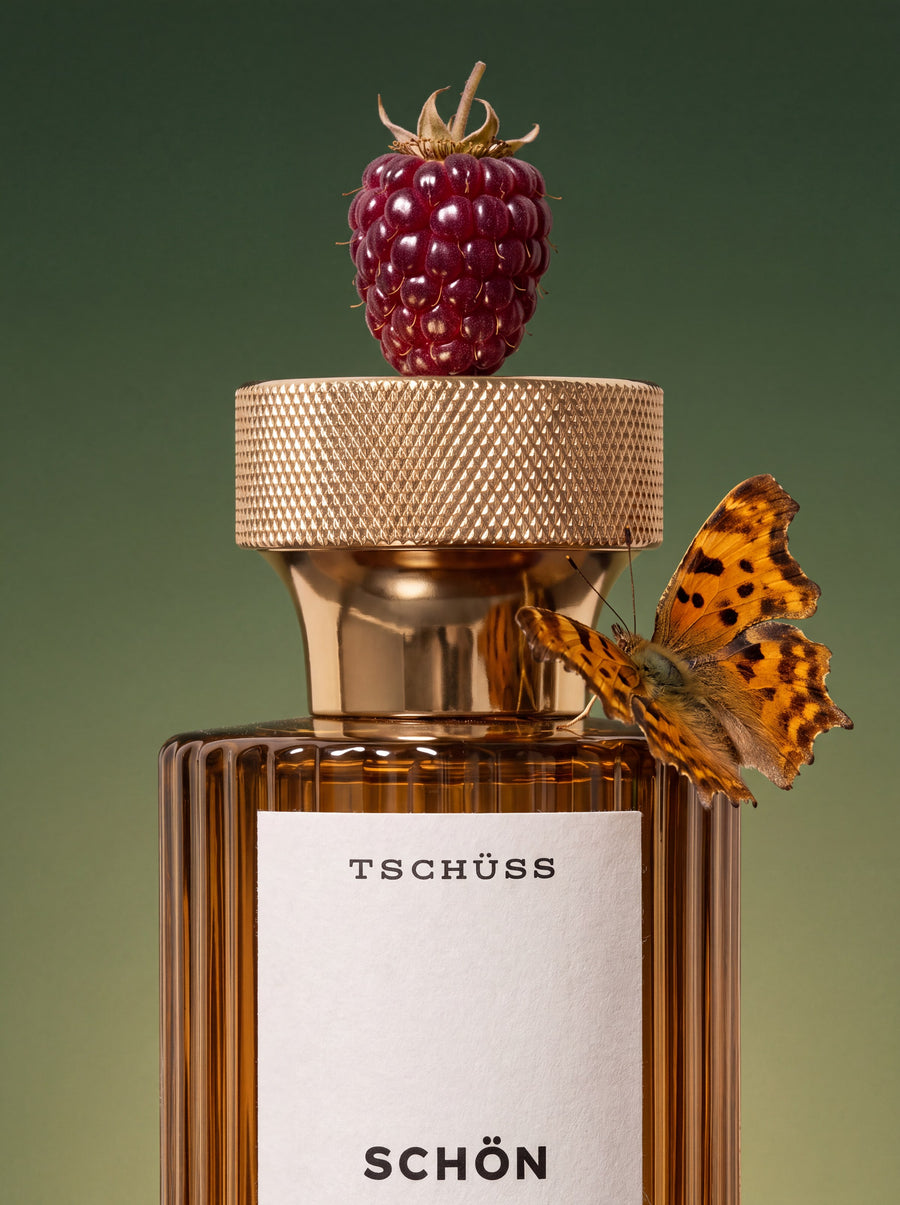 Schön bottle with a blackberry on the cap and a butterfly